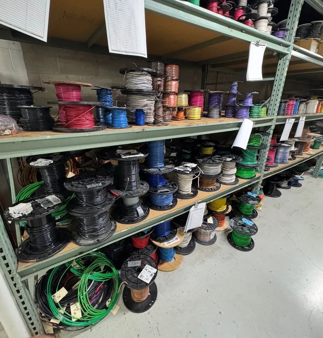 Shelves of partial wire spools in many colors