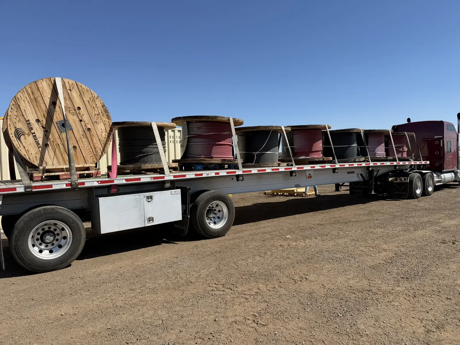 Flatbed trailer loaded with cable reels