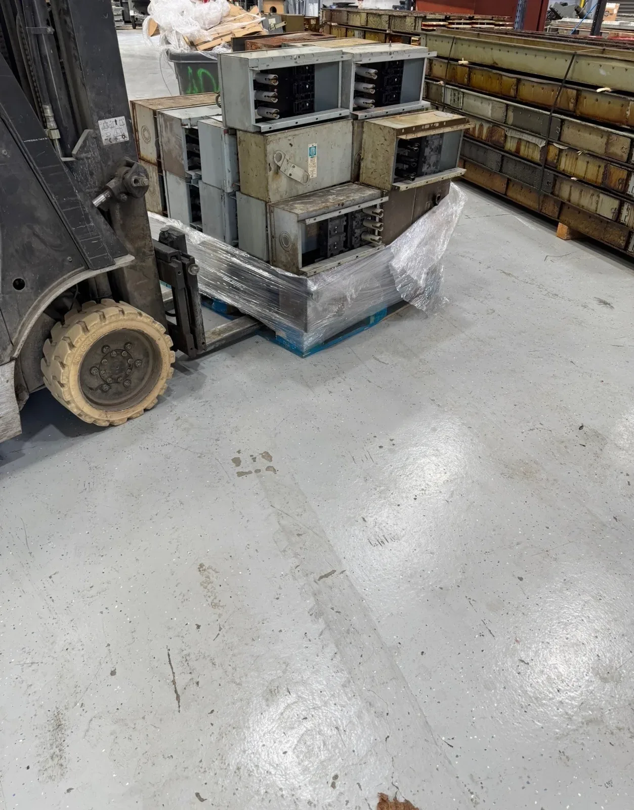Forklift moving a pallet of bus plugs