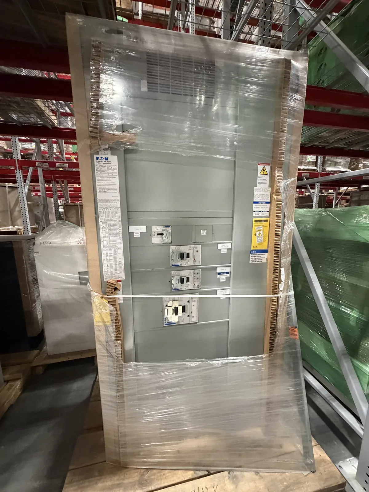 New switchboard wrapped in plastic in a warehouse