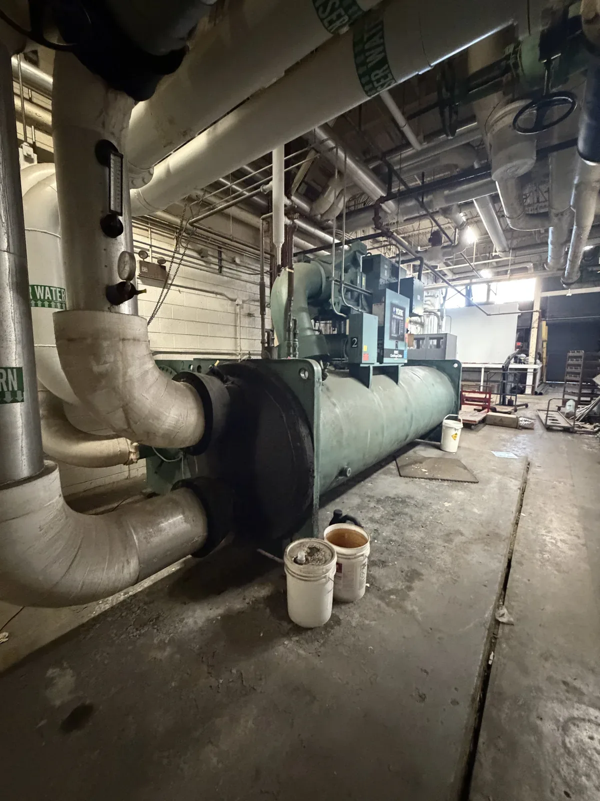 Industrial chiller and piping inside a plant being cleared out