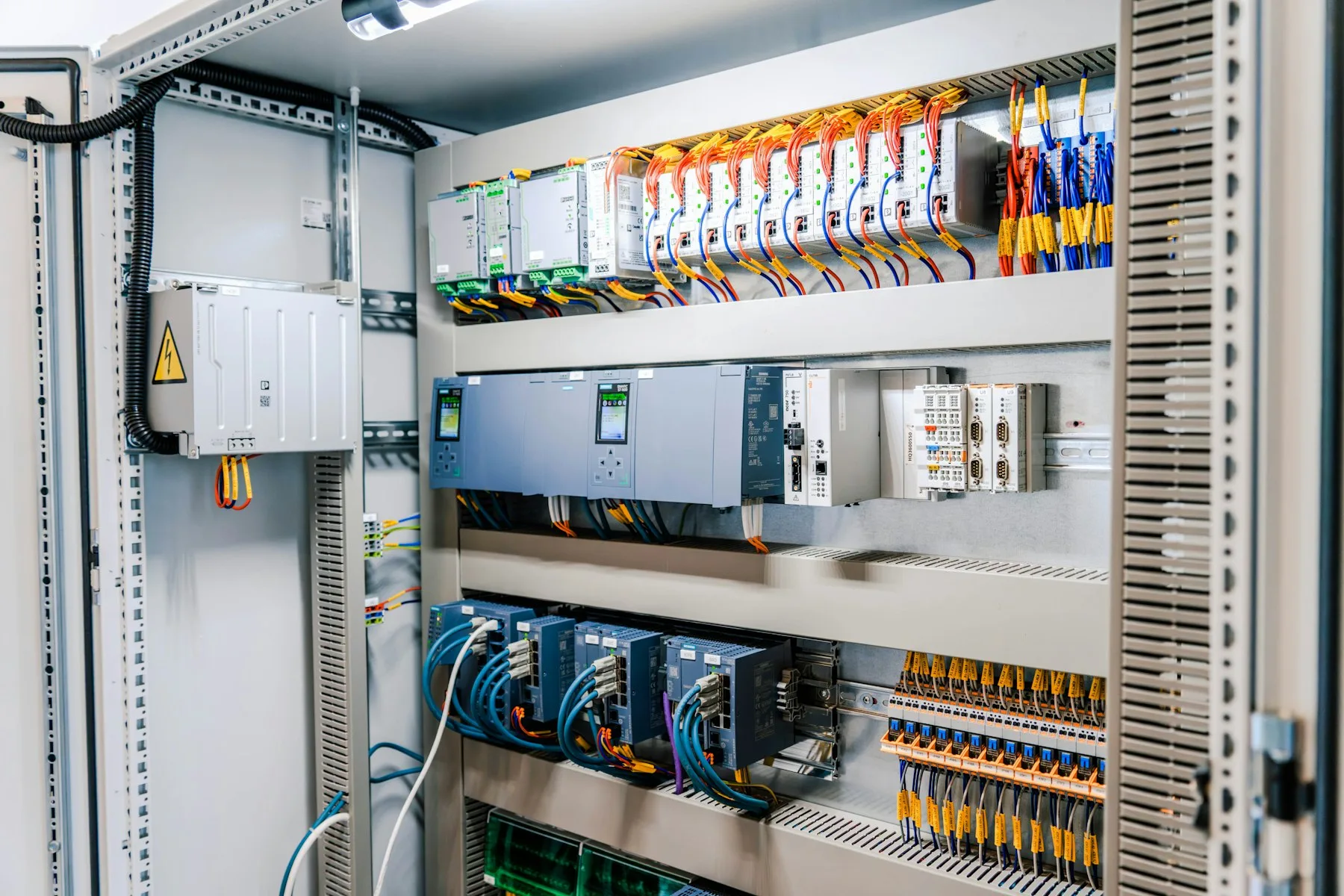 Control cabinet with PLCs, power supplies and terminal blocks
