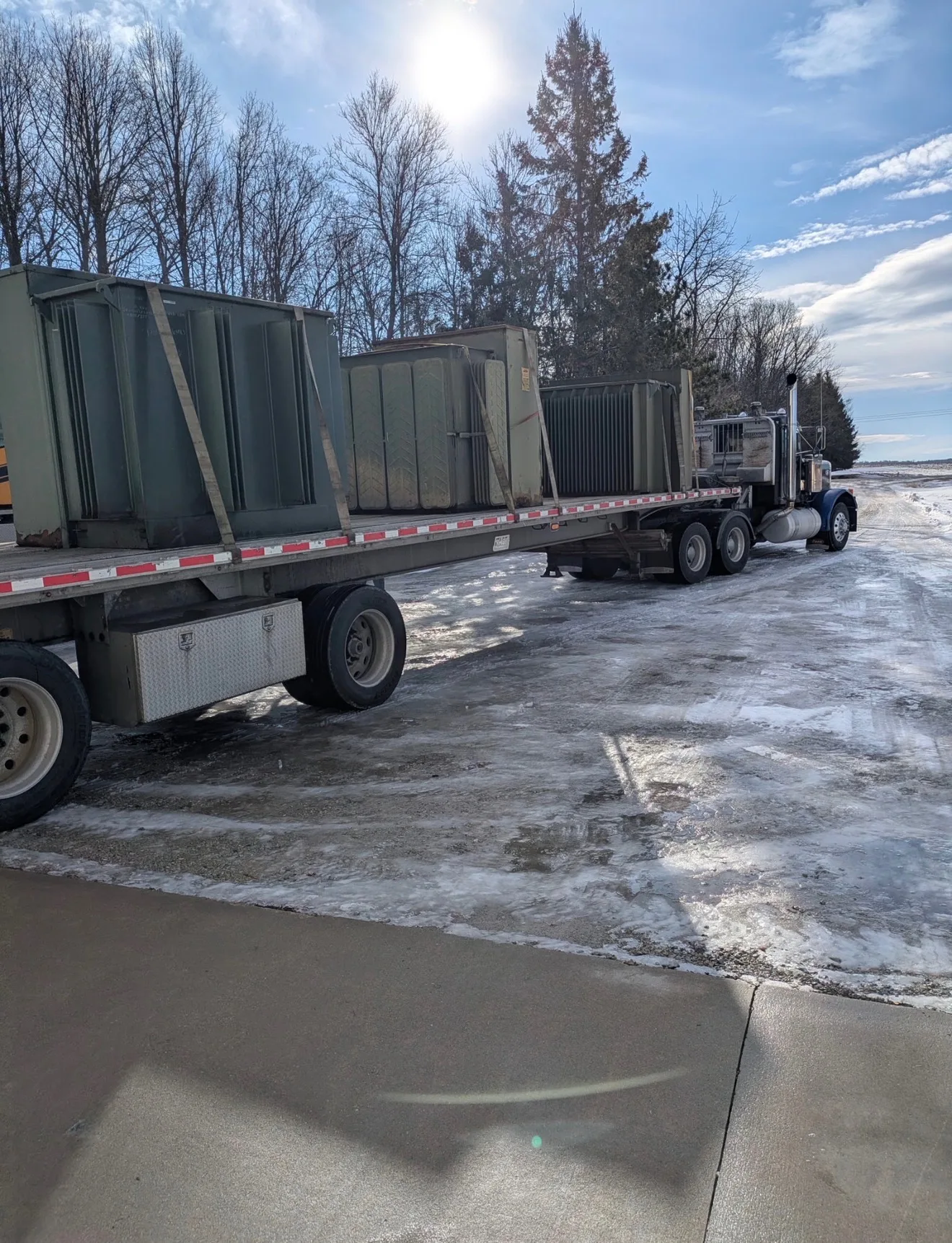 Flatbed trailer loaded with pad mount transformers